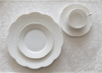 White China Place Setting on White Tablecloth 