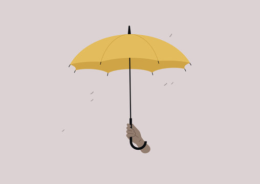 An isolated image of a human hand holding an open yellow umbrella, a rain protection