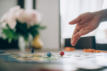 Board game and hands roll dice close-up.