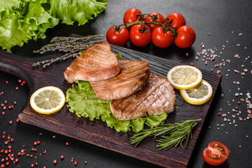 Delicious juicy tuna steak grilled with spices and herbs