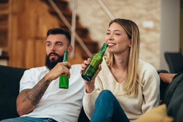 Couple drinking beer at home