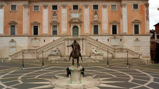 Aerial view of Campidoglio or Capitoline Hill, seat of City Council of Rome, with the statue of Marcus Aurelius and Colosseum or Coliseum and Roman Forum in the background, landmarks in Rome, Italy
