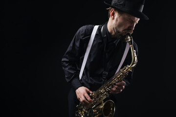 Fototapeta na wymiar Male artist playing on saxophone