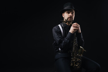 Artist posing with saxophone