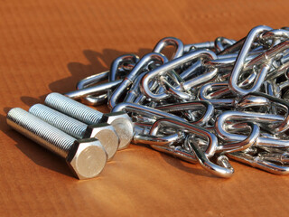 chrome chain and fasteners close-up scattered on the surface of the background for the magazine