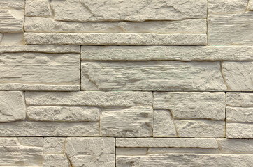 Tile for cladding a house under a stone.
