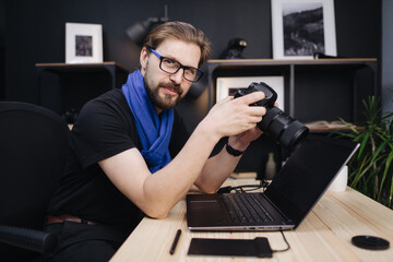 Man using photo camera indoors