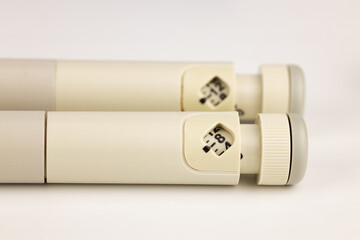 Insulin injectable pens on white background, close up