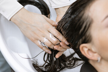 applying hair care products in a beauty salon