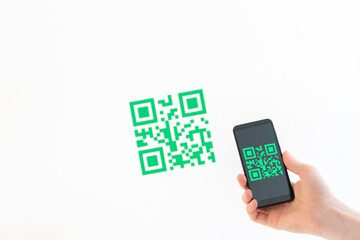 hand holding a smartphone and scan the qr code to make a payment