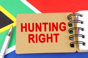 Against the background of the flag of South Africa lies a notebook with the inscription - HUNTING RIGHT