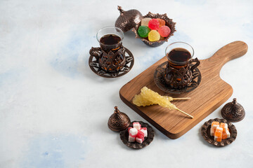 Obraz na płótnie Canvas Turkish tea set. Fragrant tea and sweet candies on white background