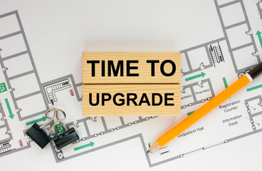 Construction drawings and wooden bars with text Time To Upgrade and paper clips