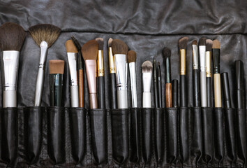 Naklejka premium set of makeup brushes in a black case, a concept of a make-up and a visit to a beauty salon