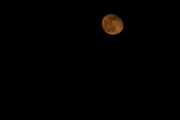 Red full moon in the night sky