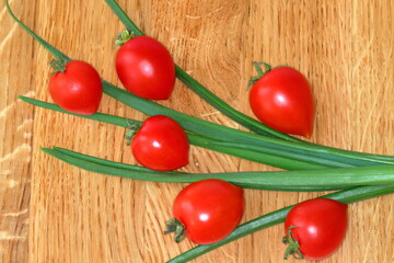 Food background. Space for text. Cherry tomato, green onion. Still life. Healthy vegetarian cuisine. 