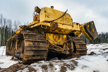 Fototapeta premium Old abandoned faulty construction bulldozer equipment. Disassembled crawler tractor at a construction site. Broken pipelayer.