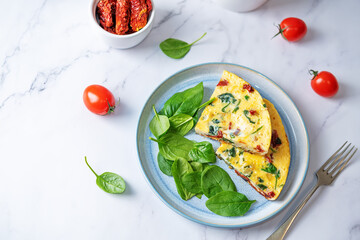 Spinach Dried tomatoes Frittata in a plate