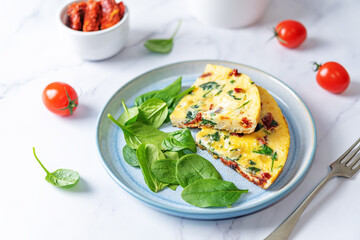 Spinach Dried tomatoes Frittata in a plate