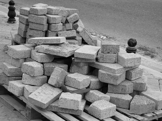 Gray solid concrete construction building bricks on a wooden pallet-Paving bricks