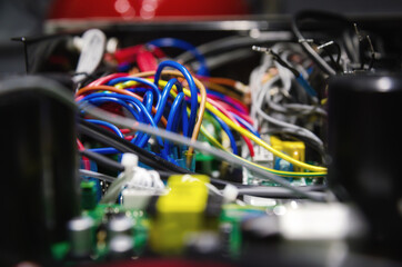 computer electrical board with connected wires close up