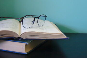 High brow eyeglasses on an open book
