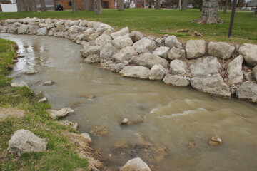 Running stream by a rocky bank