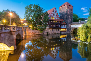 A colourful and picturesque view of the half-timbered old houses on the banks of the Pegnitz river in Nuremberg, Franconia Germany, illuminated at night