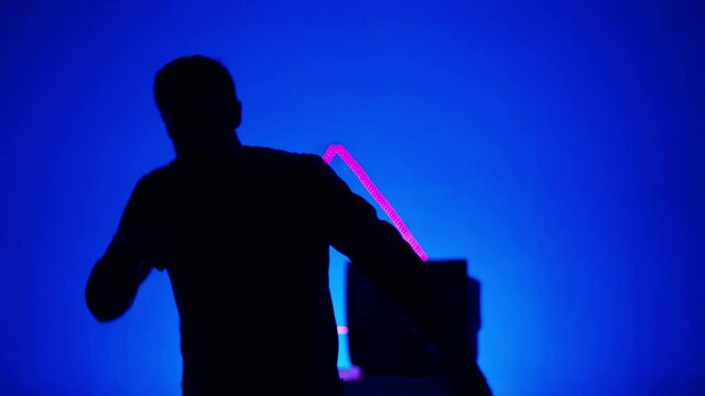 Dancer dances in silhouette. Neon, LED light, futuristic, cyberpunk dance