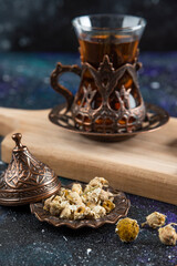 Obraz na płótnie Canvas Vertical photo of Fragrant tea behind of various herbs