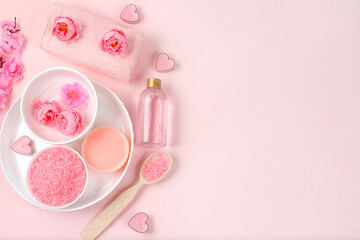 Spa and wellness composition with aromatic rose water, salt, roses and sakura, towels, aromatherapy and skin care, lifestyle concept, invitation and advertising card, selective focus