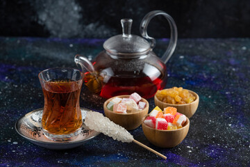 Tea set with Turkish delights on blue background