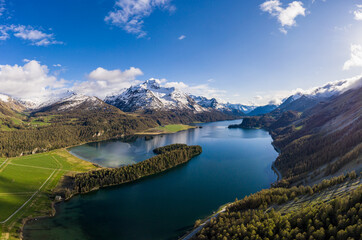 Stunning aerial view of lake Sils in Canton Graubunden in the alps in Switzerland with the Piz Corvatsch