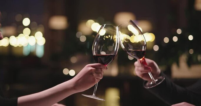 Joyful couple having a romantic dinner at a fancy restaurant. People enjoying their date, drinking wine, eating and chatting 4k footage