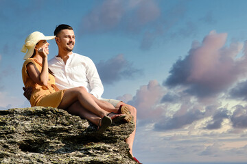 Happy couple hugging on the top of a mountain.