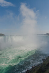Horseshoe falls, a part of Niagara Falls on Niagara river ,with a tall cloud of water splashes