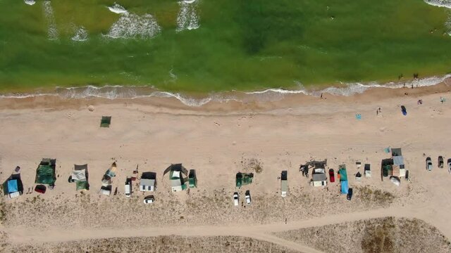 Tourist car camping with tents by the sea. Aerial view