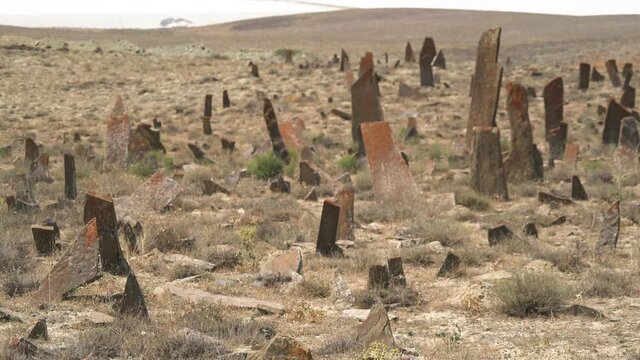 Tombstones and obelisks in the prehistoric cemetery.Anthropomorphic kurgan stone stelae statue menhirs steles ancient monument.Menhir orthostat lith old bronze age megalith Stele mass graveyard grave 
