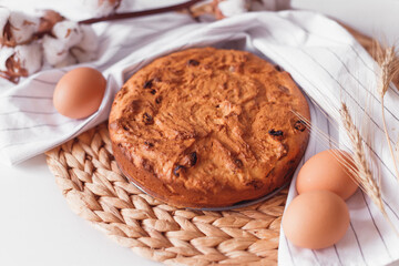 Easter cake and eggs on wicker cloth. Top view copy space. Isolated on white. Cookies pie or cake recipe
