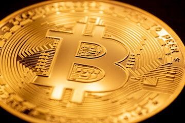 Golden bitcoin coin closeup. Bitcoins. Physical bit coins. Digital currency. Cryptocurrency mining concept.