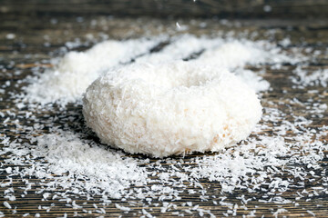 a fresh doughnut covered with white chocolate and coconut