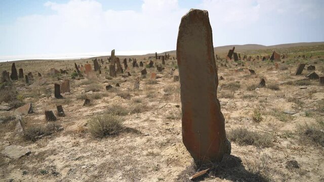 Tombstones and obelisks in the prehistoric cemetery.Anthropomorphic kurgan stone stelae statue menhirs steles ancient monument.Menhir orthostat lith old bronze age megalith Stele mass graveyard grave 