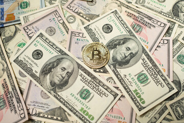 Bitcoin coin on top of Dollar Bills and Banknotes, Digityl Crypto currency and Fiat Money. USD, United States Dollar Money and Cash