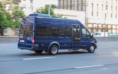 minibus moves along a city street