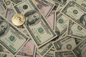 Bitcoin coin on top of Dollar Bills and Banknotes, Digital Crypto currency and Fiat Money. USD, United States Dollar Money and Cash