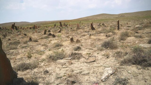 Tombstones and obelisks in the prehistoric cemetery.Anthropomorphic kurgan stone stelae statue menhirs steles ancient monument.Menhir orthostat lith old bronze age megalith Stele mass graveyard grave 