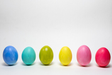 Six colorful eggs on white background.  Standing up. Creative Easter background