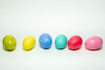 Six colorful eggs on white background. Creative Easter background