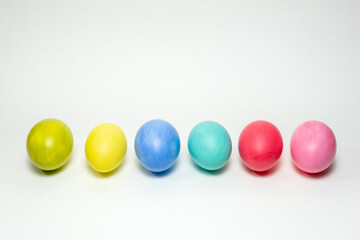 Six colorful eggs on white background. Creative Easter background
