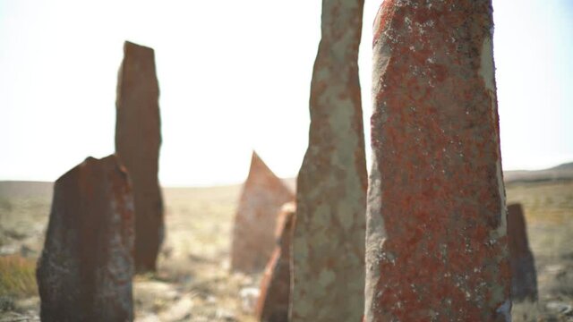 Tombstones and obelisks in the prehistoric cemetery.Anthropomorphic kurgan stone stelae statue menhirs steles ancient monument.Menhir orthostat lith old bronze age megalith Stele mass graveyard grave 